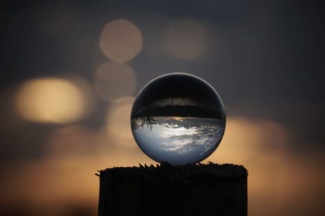 close up crystal ball against cloudy sky during sunset